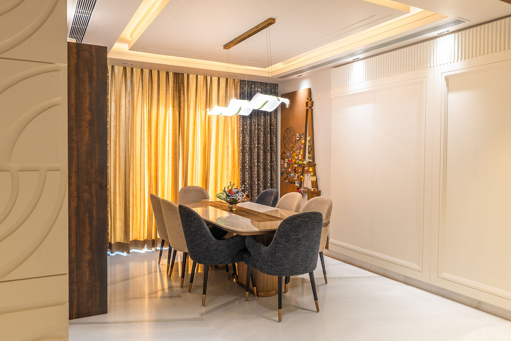 Dining room with table and chairs. Decorative curtains and lighting. RESIDENTIAL setting.