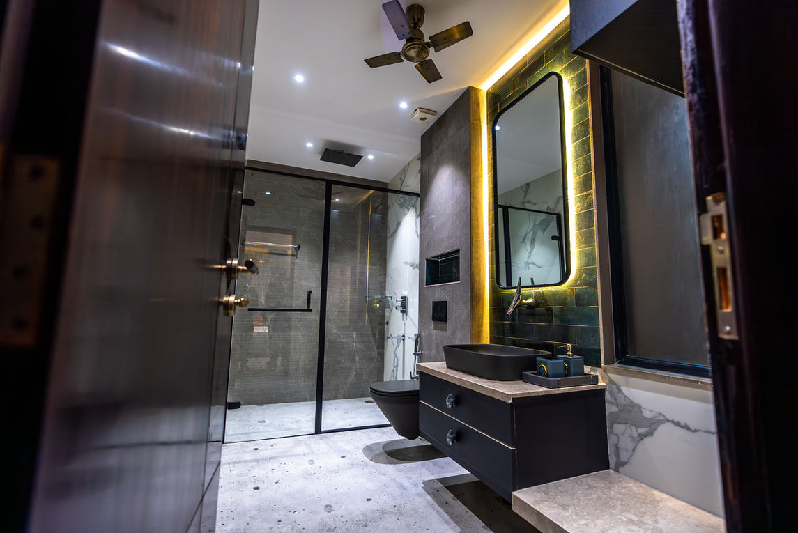 Modern bathroom with black vanity, mirror, shower, and toilet. Contemporary design elements.
