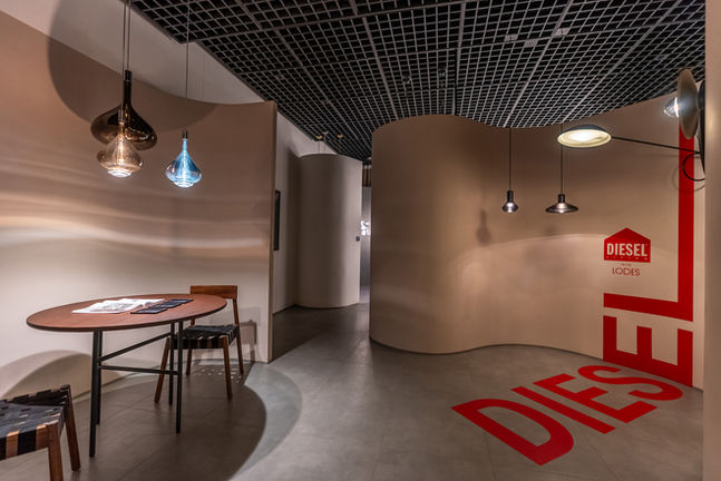Interior view of a modern building with hanging lights and flooring art.