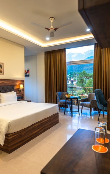 Rooms at Aotel by Clarks Inn Palampur, spacious and elegant interiors, cozy lighting, modern decor, comfortable furnishings, warm ambiance, serene environment, luxury hotel stay, tranquil vibes, refined aesthetics, stylish design, light-filled spaces, inviting atmosphere, attention to detail, upscale comfort, picturesque views, premium room experience, soothing colors, harmonious decor, relaxing retreat, tasteful furnishings, vibrant yet calming, functional elegance, contemporary style, serene getaway, scenic surroundings, Palampur hospitality, personalized comfort, relaxing ambiance, charming interiors, cozy and inviting rooms, sophisticated stay experience.