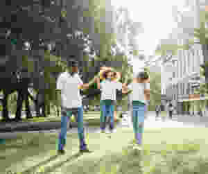 a man and a woman assisting a girl while jumping