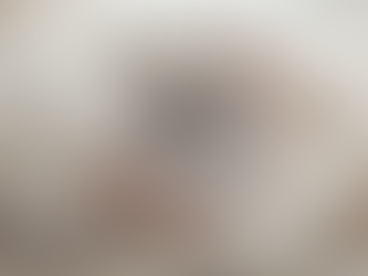 Woman in a cream knit sweater holding a warm cup of tea in soft natural light, symbolizing rest and emotional support.