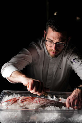 Chef Jason cutting fish