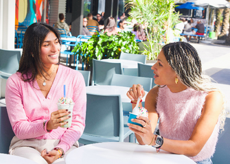 two ladies enjoying ice cream and milkshake