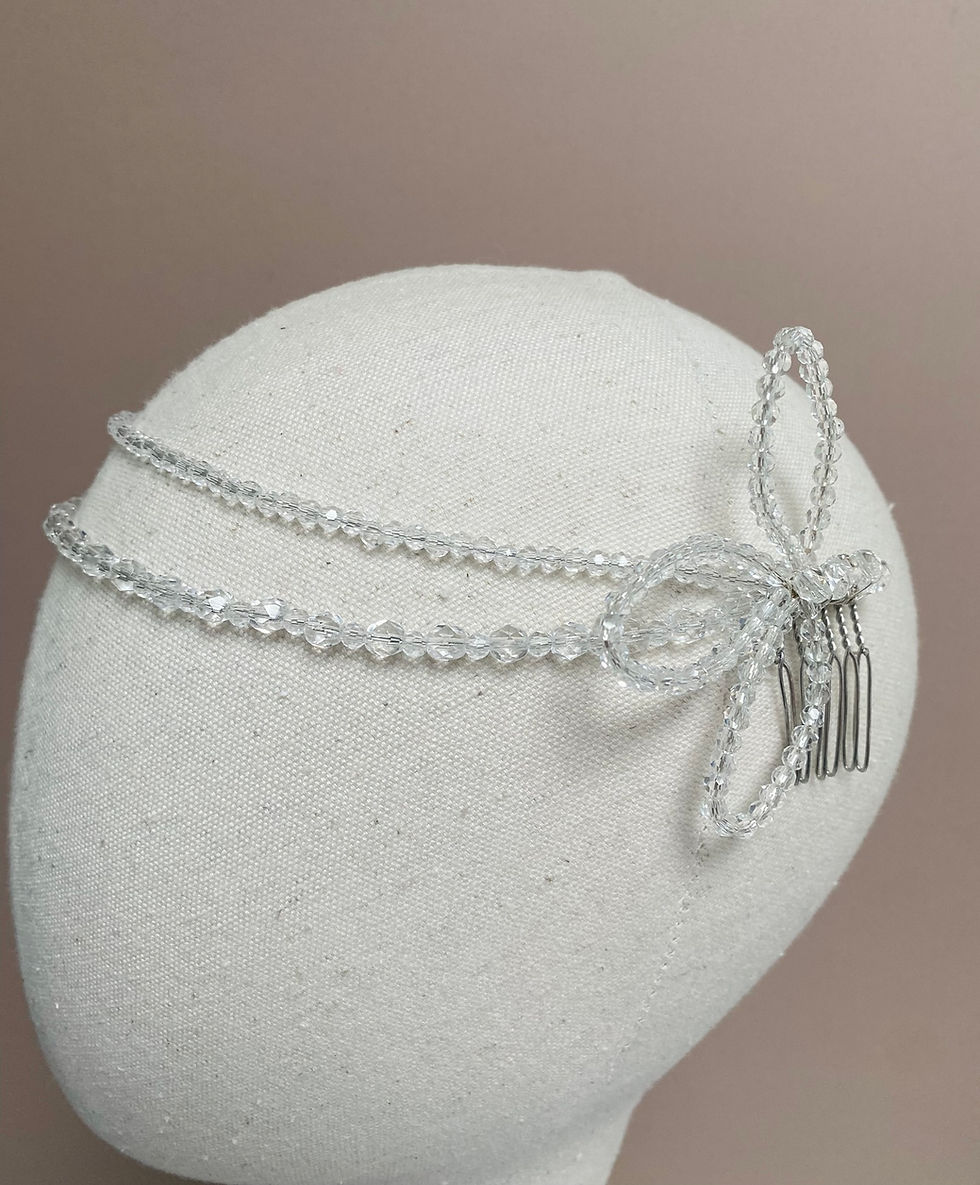 Thumbnail: A crystal bead headpiece finished with crystal leaves at the side is displayed on a mannequin head