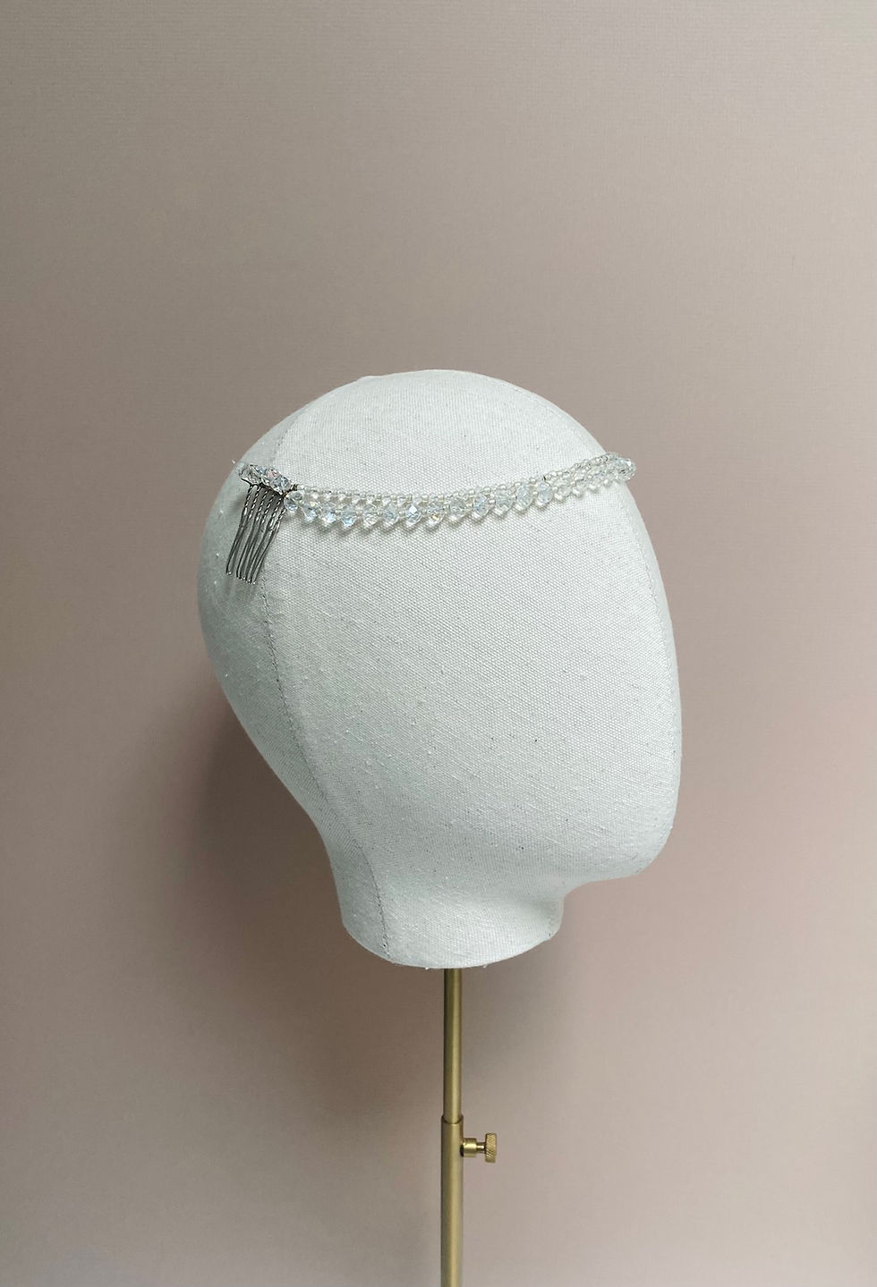 Thumbnail: A crystal bead wedding headband is displayed on a mannequin head.