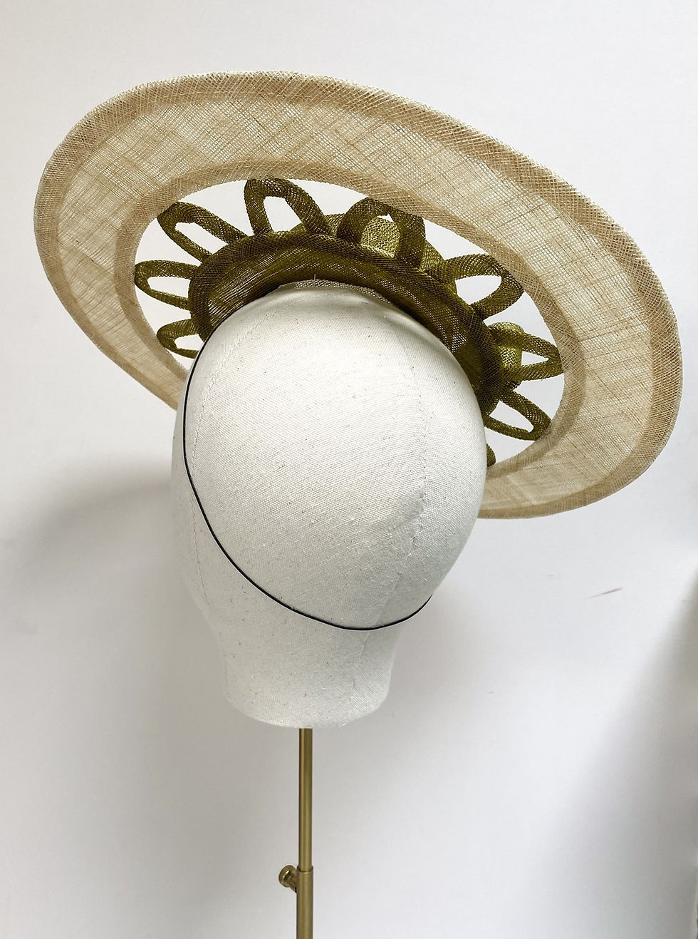 Thumbnail: A two tone women's boater hat with cut out detail is displayed on a mannequin head