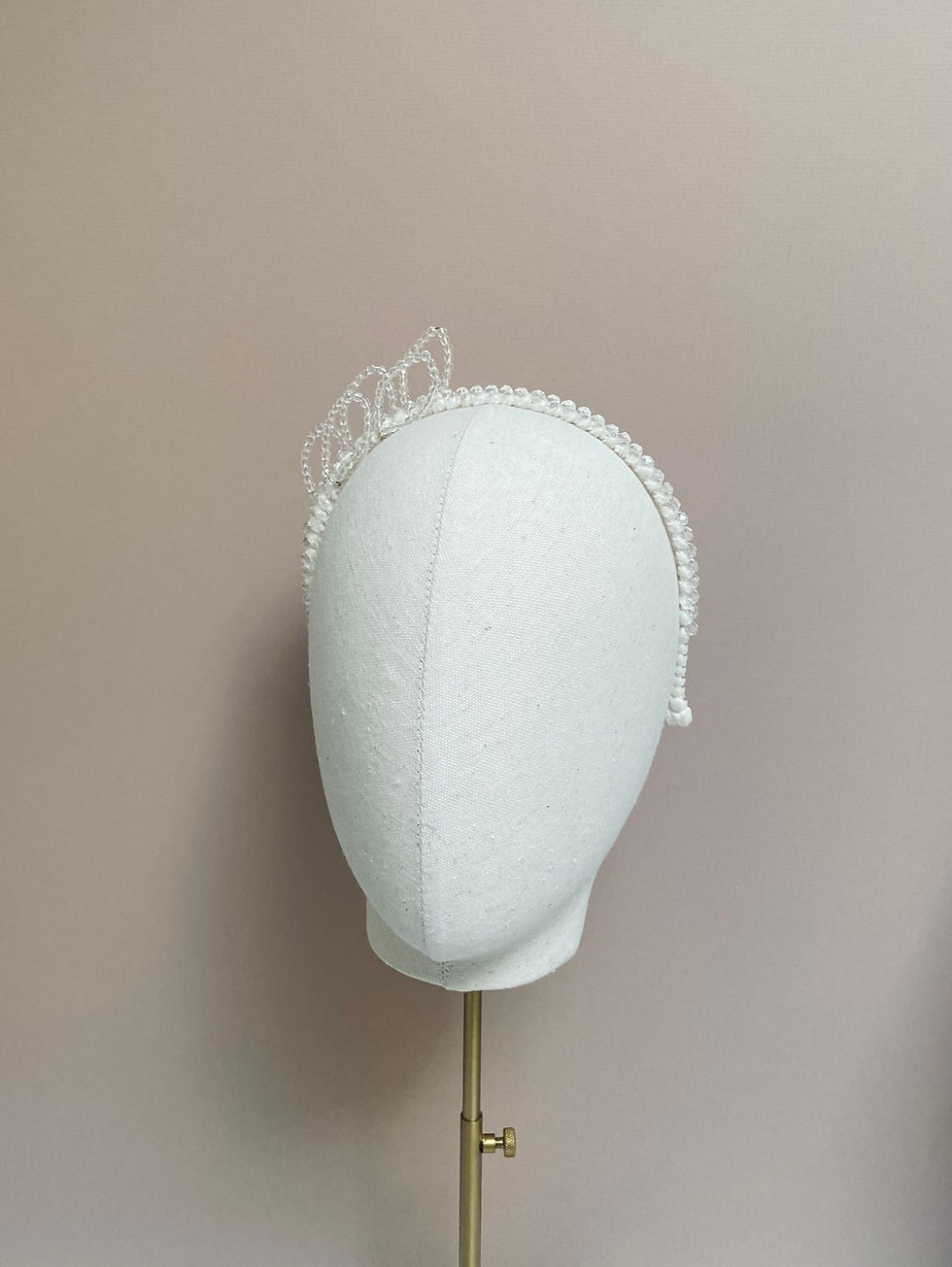 Thumbnail: A crystal beaded ivory ribbon headband with crystal leaves is displayed on a mannequin head.