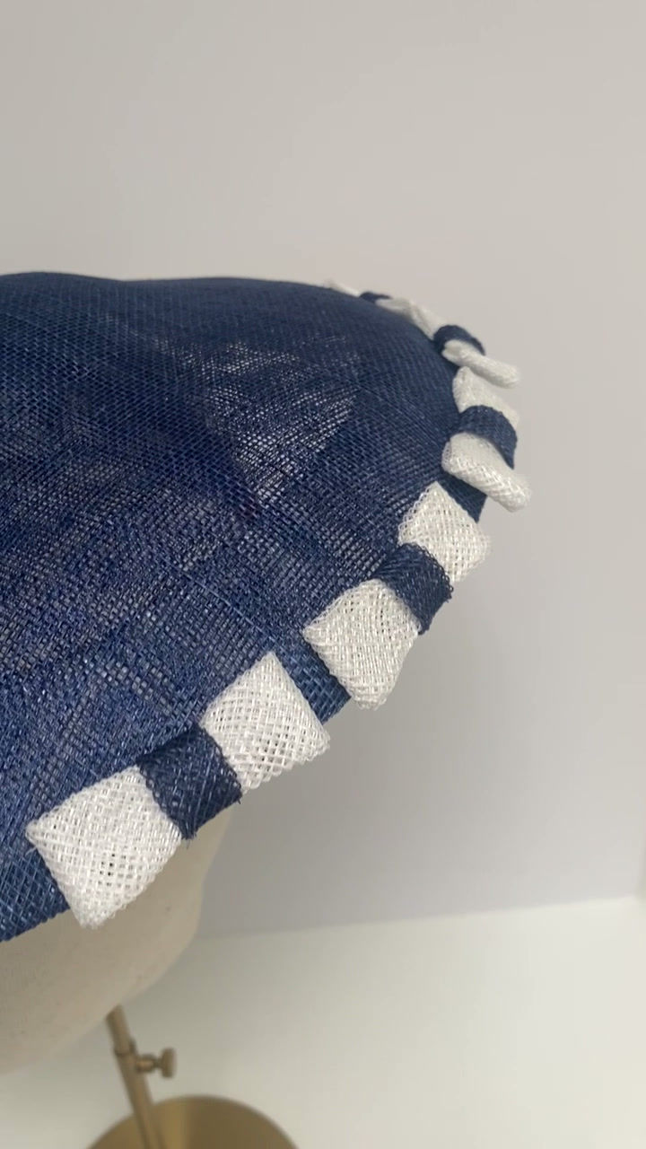 Thumbnail: A blue and white saucer hat with bows is displayed on a mannequin head