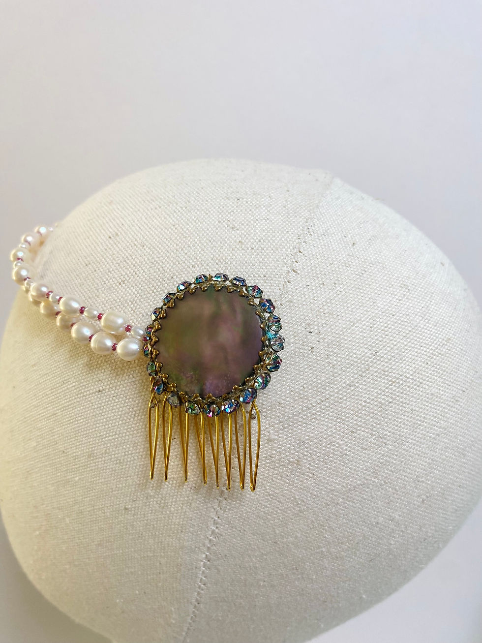 Thumbnail: A freshwater pearl headpiece with a vintage brooch is displayed on a mannequin head.