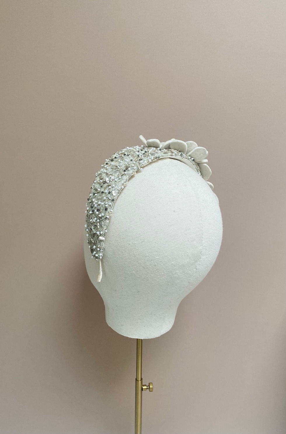 Thumbnail: An ivory flower silver beaded wedding headband is displayed on a mannequin head