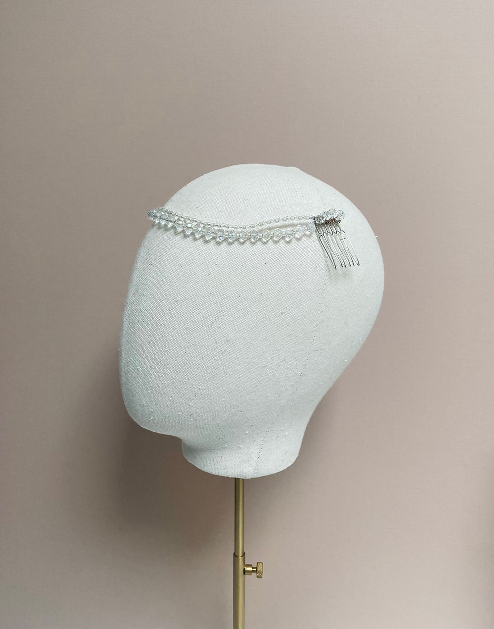 Thumbnail: A crystal bead wedding headband is displayed on a mannequin head.