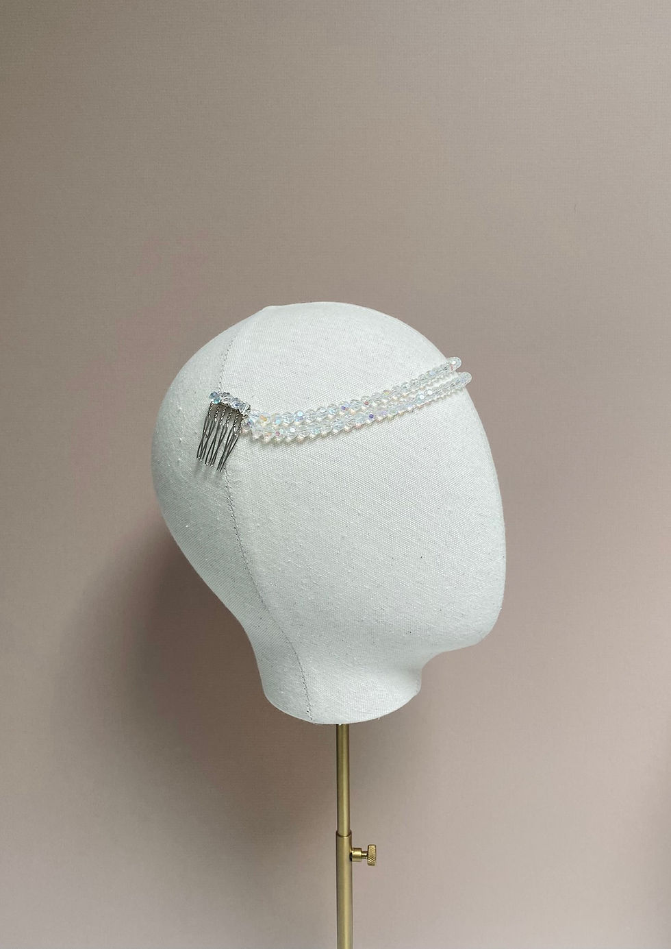 Thumbnail: A crystal beaded wedding headband with a vintage diamante brooch detail is displayed on a mannequin head.