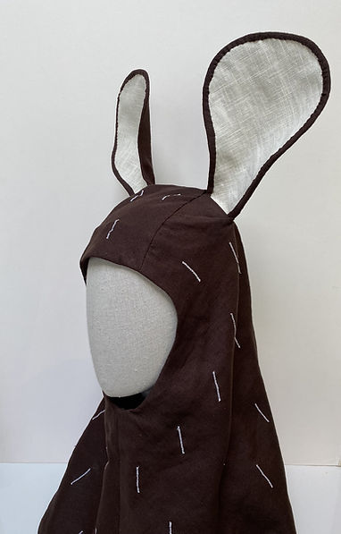 Brown fabric mouse hood with ears displayed on a mannequin head