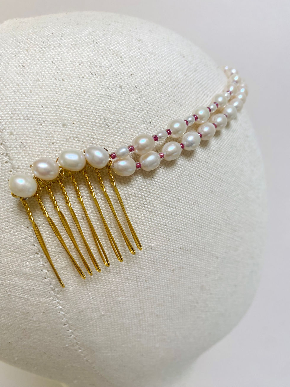 Thumbnail: A freshwater pearl headpiece with a vintage brooch is displayed on a mannequin head.