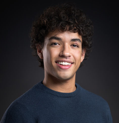 Studio actor headshot of a young man in a navy sweater with clean lighting, captured by Boulder headshot photographer Matt Crossley.
