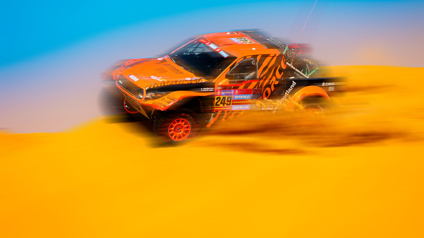 Off-road racing vehicle speeding across the desert.
