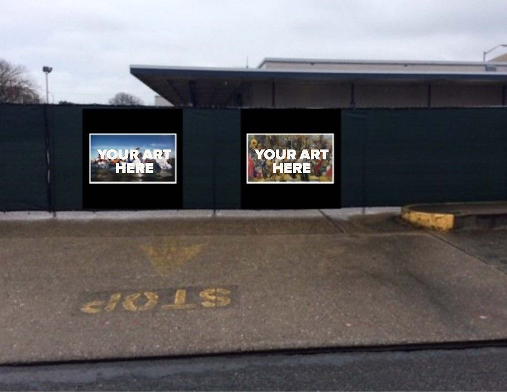 The fence around the old Greyhound Bus station with frames on it reading "Your Art Here"