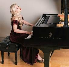 Natasha Paremski sits playing her piano, wearing a stunning deep red dress