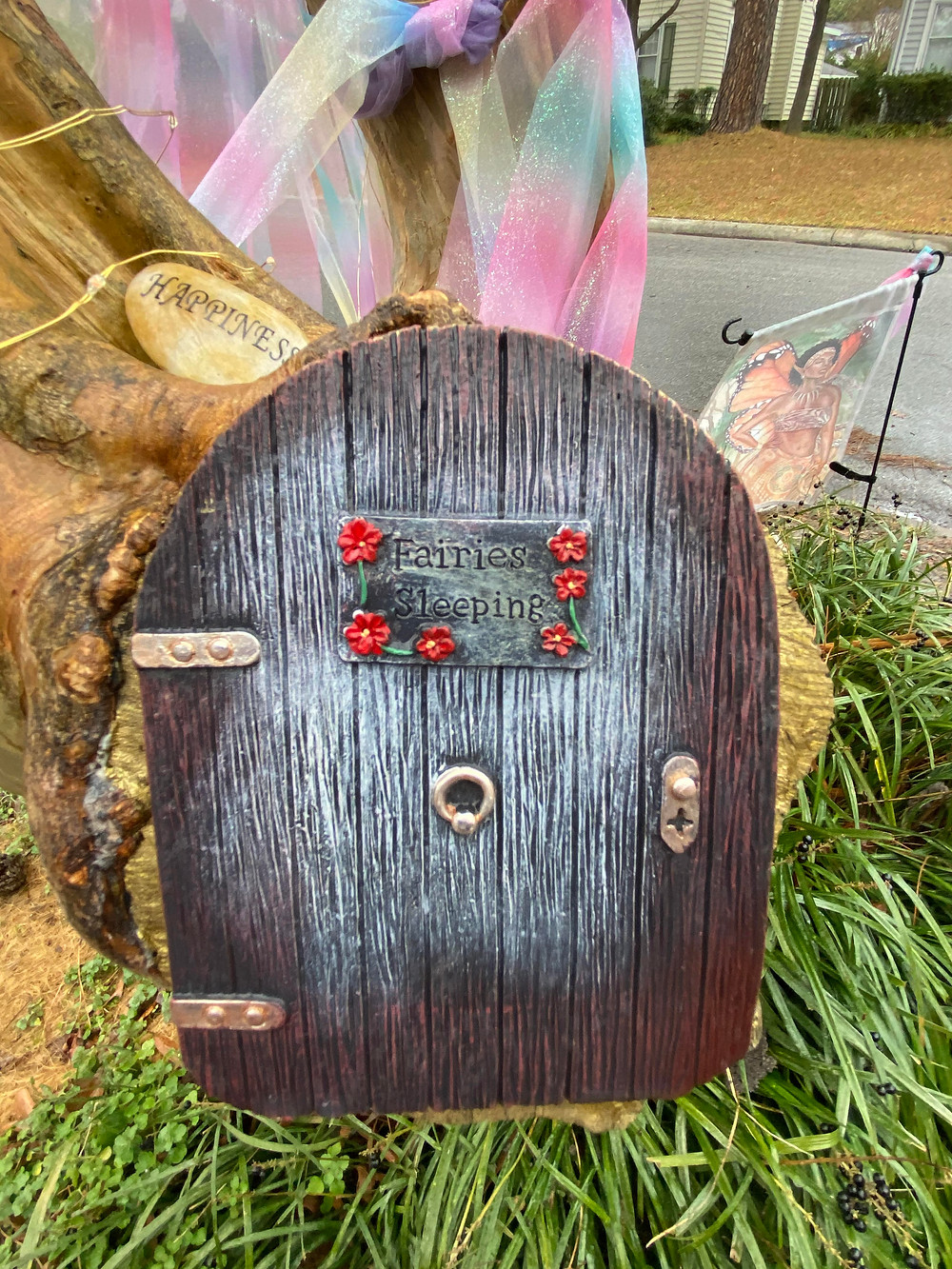 The door to the fairy tree, with a notice on it saying "Fairies Sleeping"