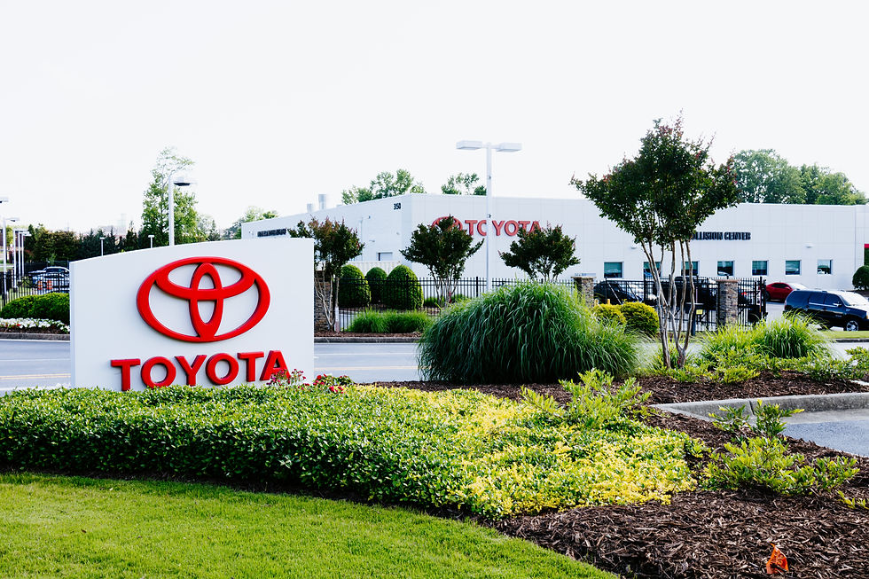 Toyota sign with green plant bed design