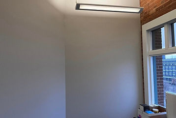 Interior painting of an office with beige walls, highlighting commercial painting services by No Hassel Painting.
