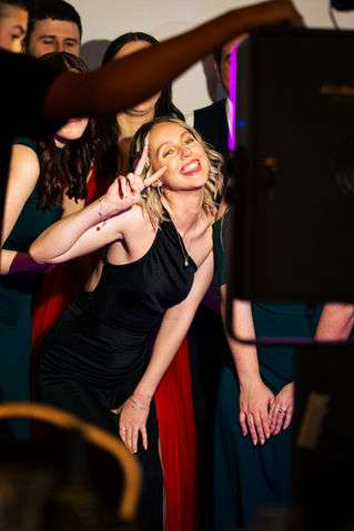 Party guests enjoying the photo booth experience with fun props and themed background