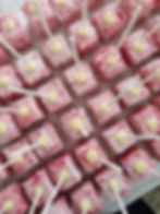large amount of raspberry marshmallow wedding favours being made