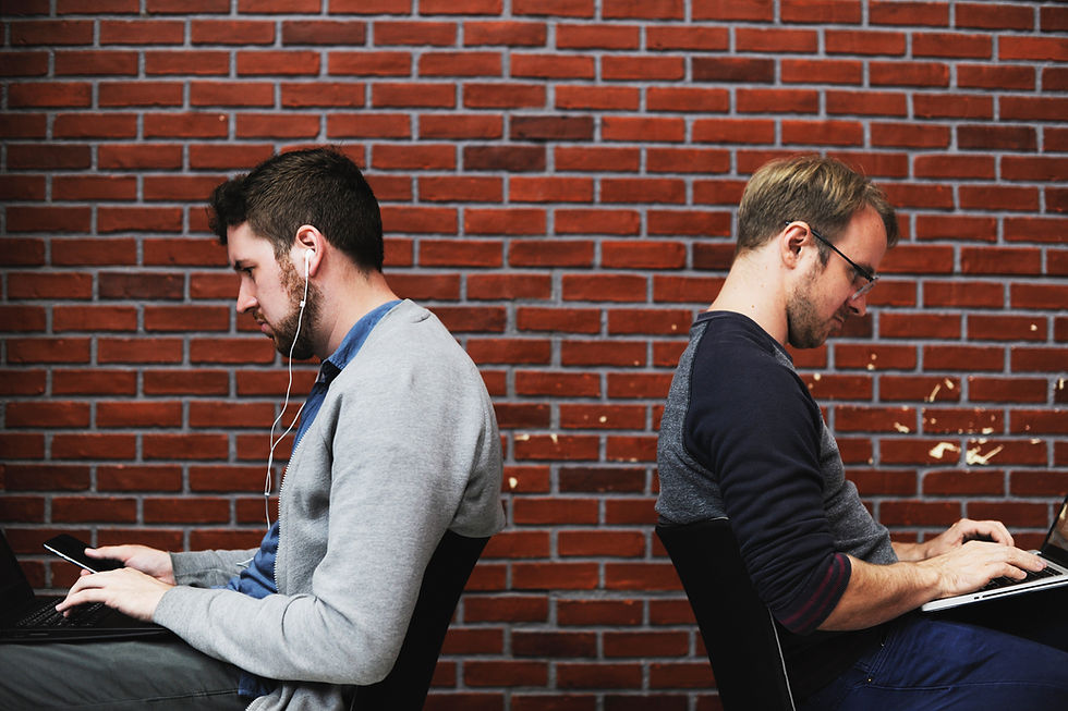 two men on computers and phone
