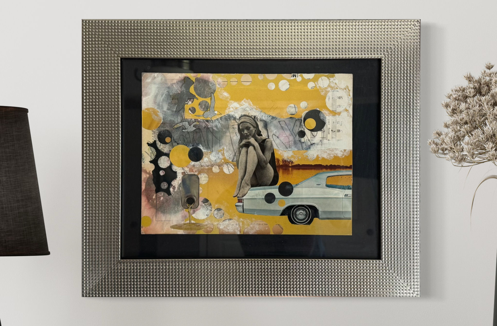 Black and White Vintaage woman sitting on the back of a vintage car looking down in contemplation with a yellow and grey back