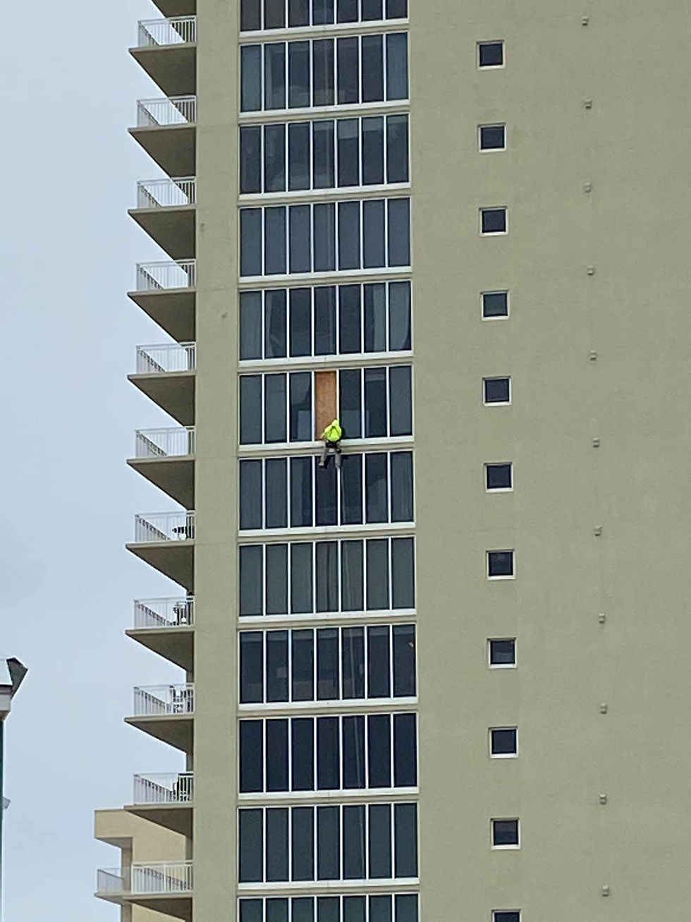 Instaling temporary repairs after hurricane damage.