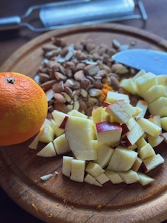 chopped apple and almonds along with grated orange zest ready for putting into granola