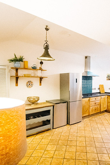 Large kitchen with tiled floor and white walls in The Barn, self catering accomodation at The George Hotel Inveraray Argyll Scotland.
