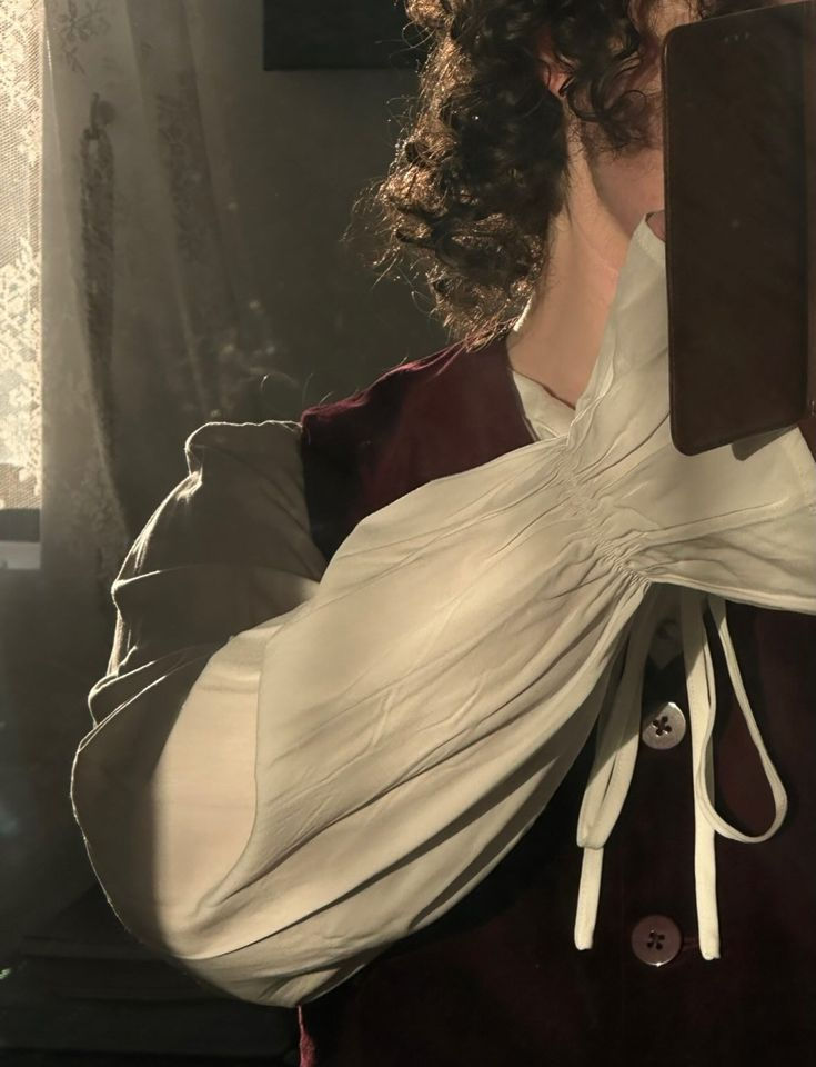 Me,  wearing a renaissance blouse and a burgundy velvet waistcoat. I wish I could dress like this all the time.