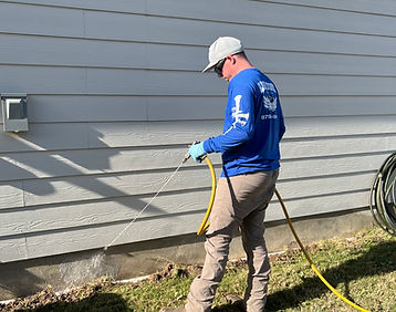 Pest Control Technician treating a home