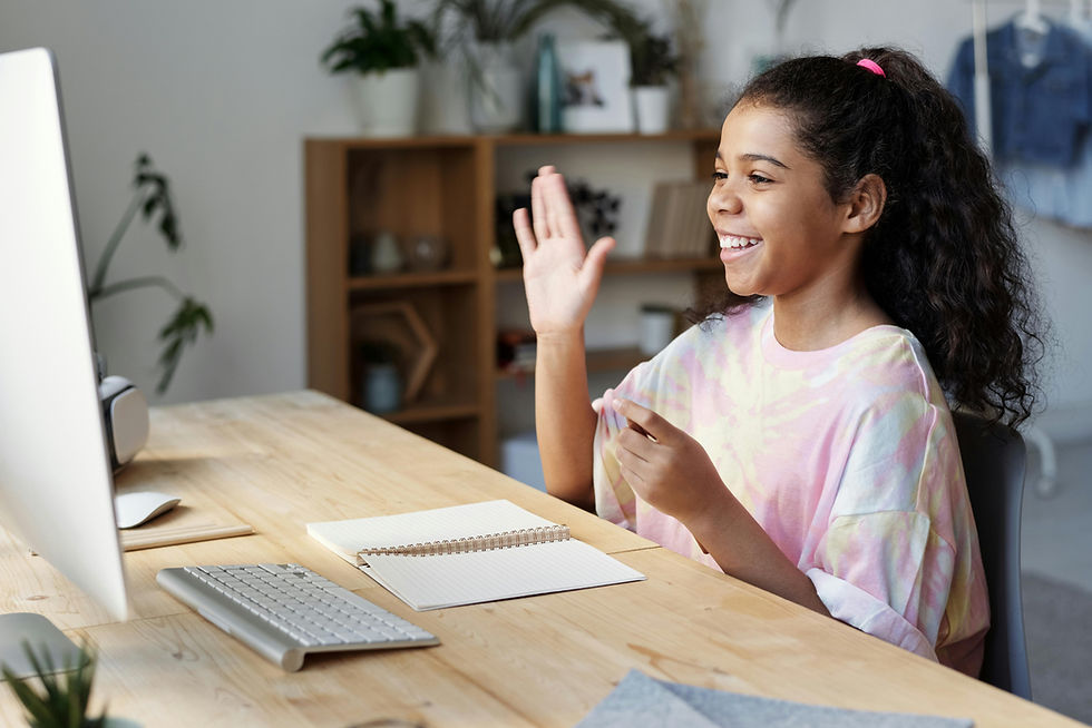 Woman in Pink Shirt Sitting by the Table While Smiling Julia M Cameron/Pexels