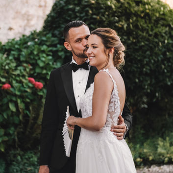 Bride and groom embrace outdoors