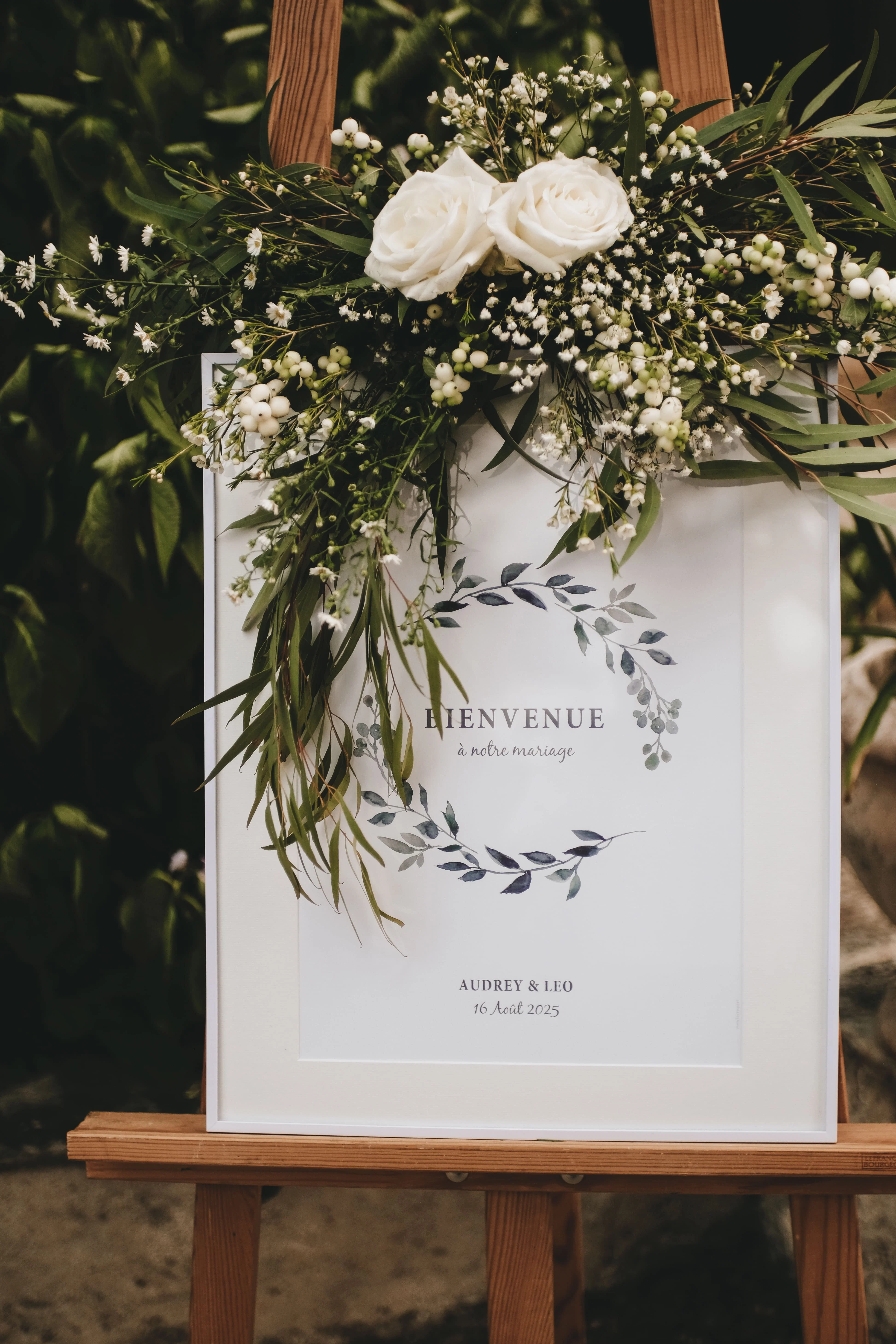 Wedding welcome sign with floral arrangement