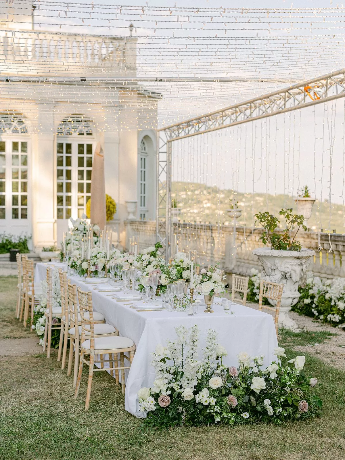 Refined outdoor reception table decorated with florals at a French chateau wedding