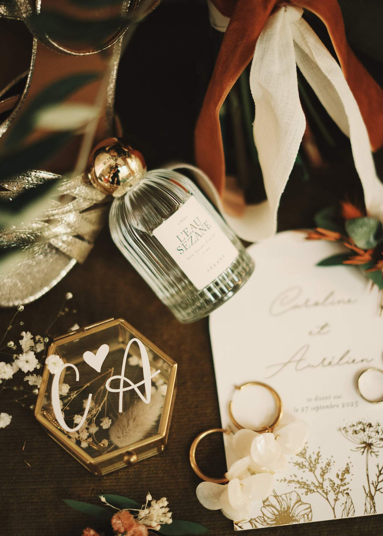 Wedding details flat lay with perfume and rings