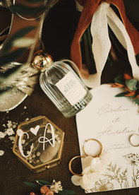 Wedding details flat lay with perfume and rings