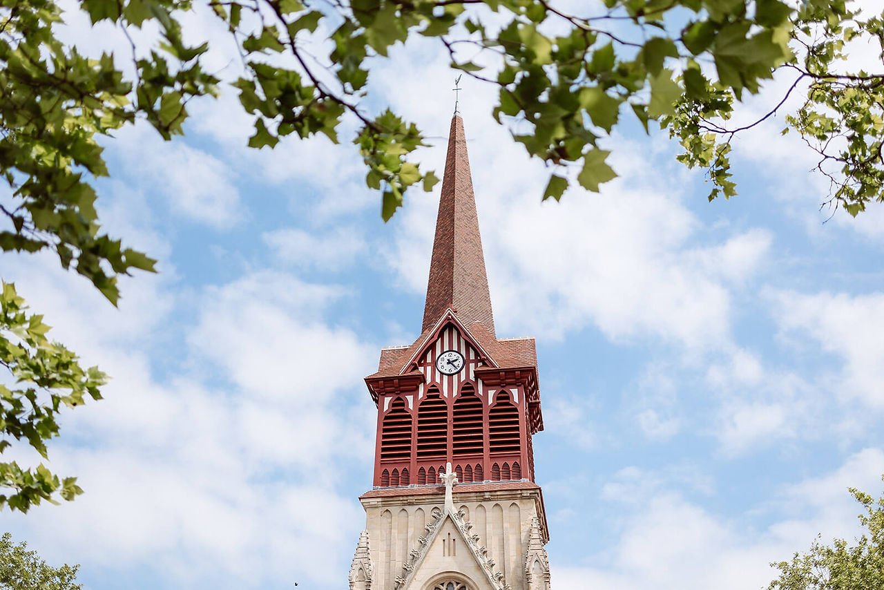 Church steeple rising against a blue sky