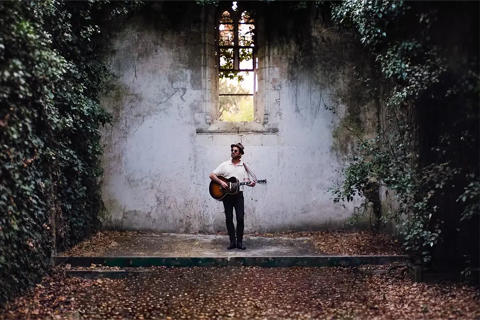 Wedding guitarist performing in an old chapel