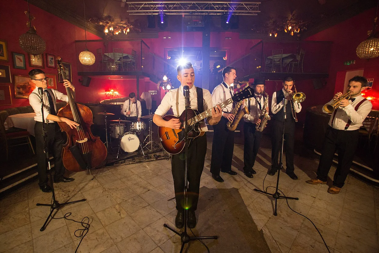Live wedding band performing indoors during an elegant French celebration
