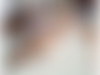 Children in chef hats making cookies in front of a hanukiah