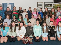 Underage girls celebrate their 2025 achievements on the playing field.