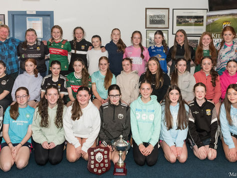 Underage girls celebrate their 2025 achievements on the playing field.