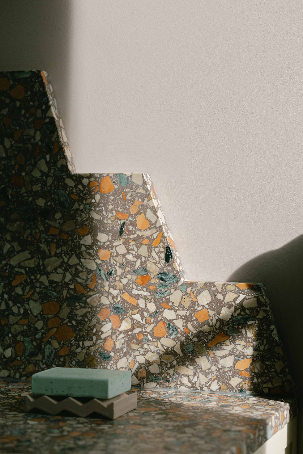 Custom terrazzo bathroom splashback with ziggurat-inspired detailing designed for a London residential renovation project