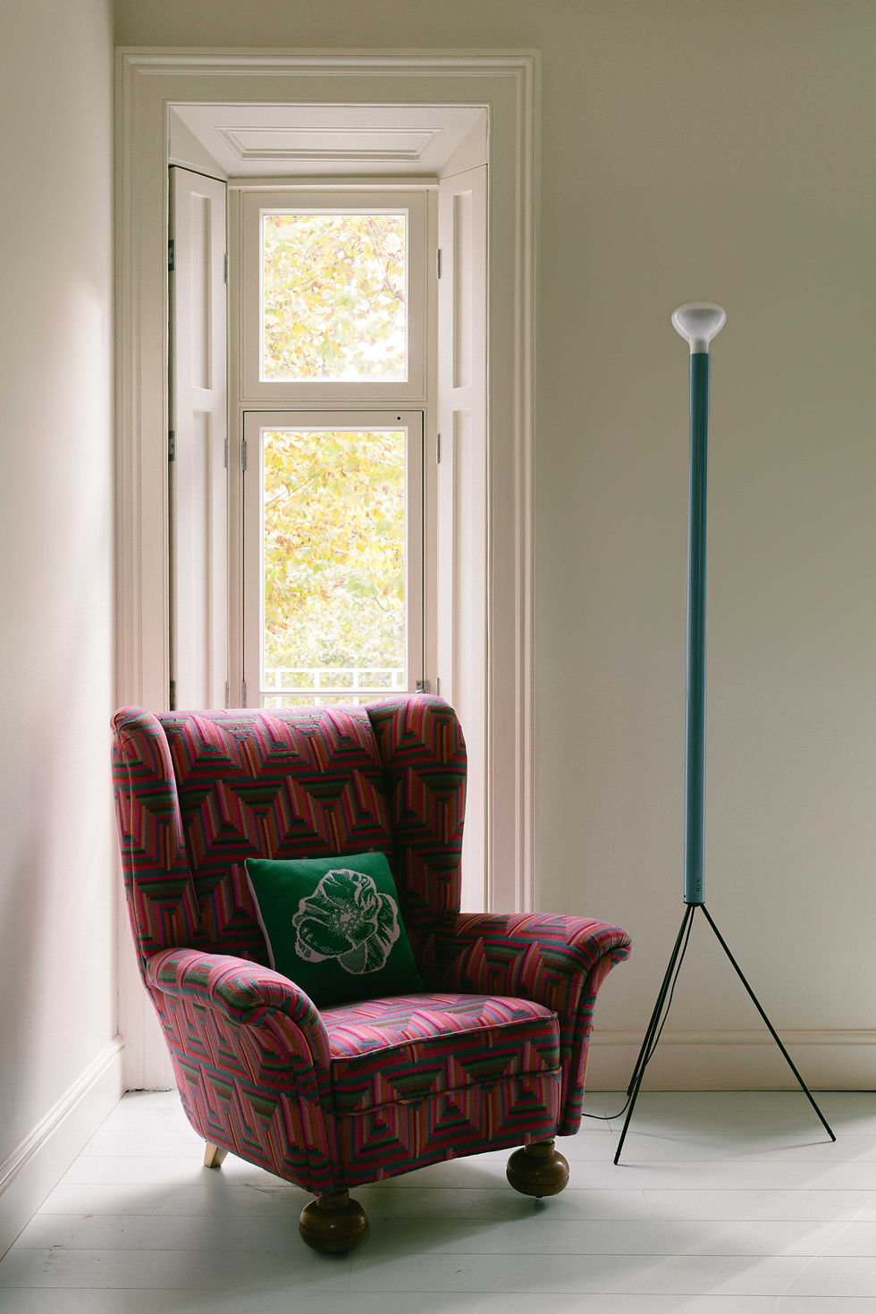 Reading corner within Victorian Terrace Waterloo by Kinder Design featuring a patterned armchair, sculptural floor lamp and soft white walls with natural autumn light.