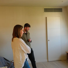 Leo Wood discussing a residential renovation project with a client during an interior design consultation, reviewing the space before work begins.